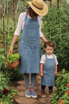 a woman and child standing in a garden