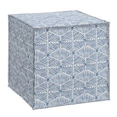 a blue and white cube shaped box with an abstract pattern on the front, sitting against a white background