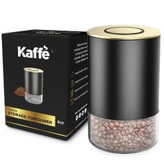 a black container with coffee beans in it next to a cardboard box