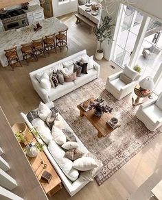 an overhead view of a living room with couches, tables and chairs in it