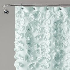 a white shower curtain with flowers on it