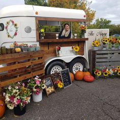 a food truck is decorated with sunflowers and pumpkins for the fall season