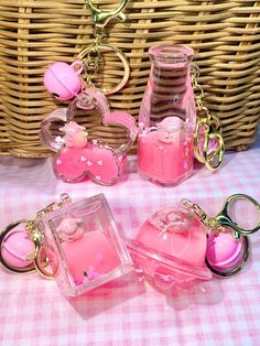 three pink items sitting on top of a table next to a wicker basket filled with stuff