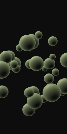 green bubbles floating in the air on a black background