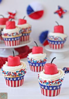 red, white and blue cupcakes with cherries on them are ready to be eaten