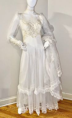 a mannequin wearing a white dress on display