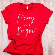 Women's 'Merry And Bright' holiday t-shirt. A classic Christmas shirt featured in a new, trendy design. A unisex fit, red tee featuring white lettering available in sizes S - 4XL. This shirt also makes a wonderful gift. Please allow 1-2 weeks for delivery on this item. Details 100% combed ring-spun cotton  Shoulder-to-shoulder taping Side-seamed Fit: Loose style unisex fit Size guide                         SMLXL2XL3XL4XL Length (inches)   28293031323334 Width (inches)18202224262830 Military Green Shirt, Leaf Shirt, Engaged Shirts, Peach Shirt, Funny Christmas Tshirts, Womens Christmas Shirts, Christmas Tree Shirt, Religious Shirt, Merry Christmas Shirts