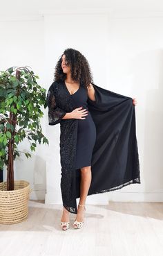 Jaw dropping piece. The Arabella kimono features a maxi silhouette, ornate sequin embellishment throughout, and finished with handmade black silk trimming for a luxurious look. Let's get this party started. Only one available DETAILS Lace embellished with sequins Handmade silk Sfifa Trimmings Fully Lined Black Maxi Length 1.40 meter /55 inch One size fits all Dry clean only Handmade in Morocco Got a question!! don't hesitate to contact me :) Festive Cape Dress For Eid, Evening Cape Dress For Eid, Cape Dresses For Evening Eid Celebrations, Cape Dresses For Eid Party, Festive Embellished Cape Dress, Wedding Dress With Cape For Eid, Floor-length Sequined Maxi Dress, Embellished Maxi Dress With Cape Sleeves For Party, Elegant Embellished Maxi Dress With Cape Sleeves