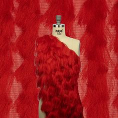 a mannequin with red feathers on it