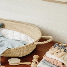 a basket with clothes and toys on the floor