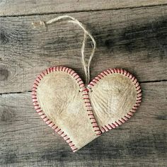 two heart shaped ornaments hanging on a string