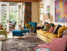 a living room filled with furniture and a dog sitting on top of the couches