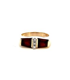 Elevate your jewelry collection with the exquisite beauty of our 14KT Yellow Gold Garnet Ring with Diamonds. This magnificent piece showcases a unique and captivating design, featuring two radiant garnet stones set in the warmth of lustrous 14KT yellow gold. The garnets, known for their deep red hue that symbolizes love and passion, are beautifully complemented by a vertical row of three round diamonds, adding a touch of sparkle and sophistication to the piece. The ring's design is a testament to expert craftsmanship, blending classic elegance with a modern flair. The contrast between the rich red of the garnets and the bright sparkle of the diamonds creates a stunning visual appeal, making this ring a perfect choice for those who appreciate fine jewelry with a distinctive character. With Fine Jewelry Yellow Gold Garnet Ring, Yellow Gold Garnet Rings With Gemstone Accents, Luxury Yellow Gold Rings With Garnet, Yellow Gold Garnet Jewelry With Polished Finish, Faceted Garnet Jewelry In Yellow Gold, Garnet And Diamond Ring, Garnet Stone, Garnet Rings, Classic Elegance