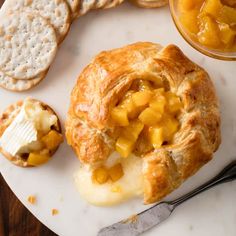 a white plate topped with food next to crackers