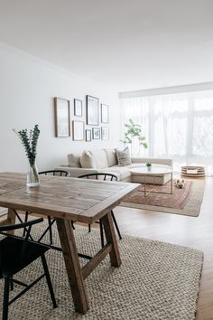 a living room filled with furniture and a wooden table