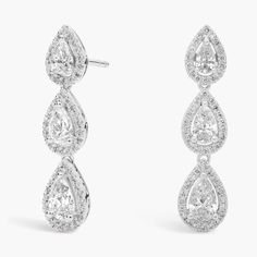 These ultra-glam drop-style earrings feature trios of gorgeous pear-cut diamonds surrounded by halos of round diamonds, all set in 14k white gold. Secure with hinged snap backs. Pear Cut Diamond, Pear Shaped Diamond, Blue Nile, Diamond Fashion, Snap Backs, Diamond Halo, Style Earrings, Diamond Drop Earrings, Pear Cut