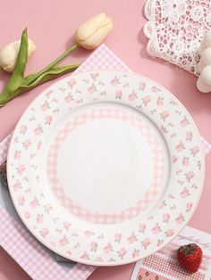 pink and white plates with gingham designs on them next to tulips