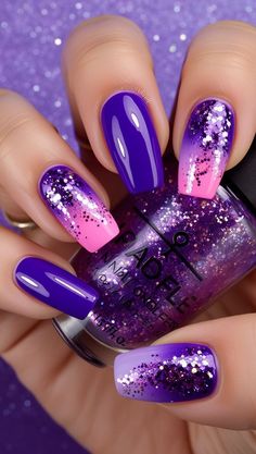 This vibrant ombre nail art features a bold combination of purple, pink, and lavender tones, accented with glitter to add a touch of sparkle and fun. A perfect choice for a standout look. #SparklingNails #OmbreNailDesign #PurpleAndPinkNails #GlitterAccentNails #BoldAndVibrant #NailArtInspiration #FunManicureIdeas #GlamorousOmbre #NailArtGoals #ShinyNails #BoldManicureStyle #NailDesignInspo Pink And Purple Nails Acrylic, Purple Glitter Nails Acrylic, Hot Pink And Purple Nails, Purple And Black Nails Designs, Glittery Purple Nails, Purple Nail Art Ideas, Purple And Pink Nails, Mardi Gras Nails, Ombre Nail Art