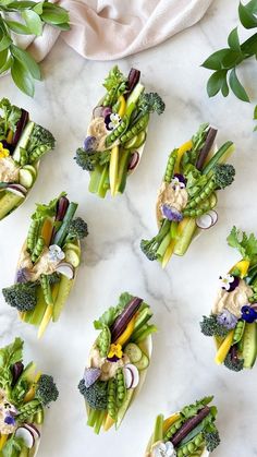 broccoli, celery, radishes and other vegetables arranged on plates