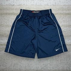 Vintage Nike Gym Shorts Navy Blue Polyester 11" Inseam White Swoosh Basketball Baggy Y2K Skate / Streetwear Great Condition: 9/10 Men's Size: Large Waist: 32" to 36" Length (inseam): 11" Leg Opening: 14" Thigh Opening: 15" Front Rise: 14" Mens Gym Shorts, Sport Nike, Baggy Y2k, Nike Vintage, Nike Sports, Grand Tour, Gym Shorts, Vintage Nike, Athletic Shorts