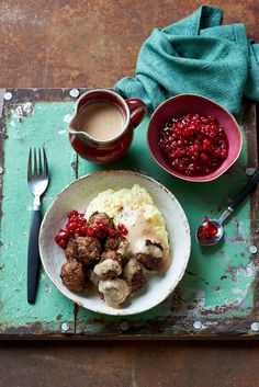 a plate with meatballs, mashed potatoes and cranberry sauce on it