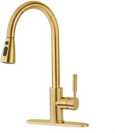 a gold faucet that is on the side of a white wall with a black handle