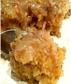 a close up of a piece of cake on a plate with a spoon in it