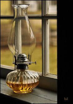 a glass vase sitting on top of a window sill