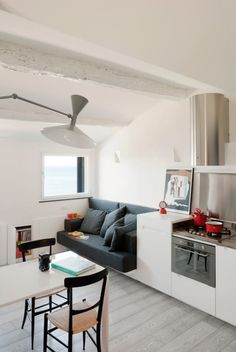 a kitchen and living room with white walls