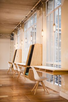 a row of chairs sitting next to each other on top of a hard wood floor