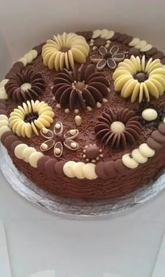 a chocolate cake with white and brown decorations