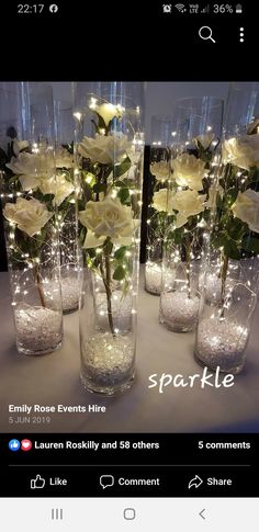 there are many vases with flowers in them and lights on the top one is white