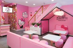 the interior of a hello kitty restaurant with pink furniture