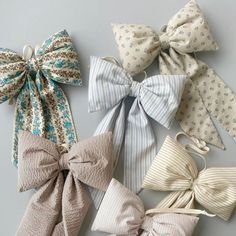 four different types of bows on a gray surface