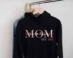 "Mama Est Hoodie, Mom Established, Custom Year, Personalized Mama Sweater, New Mom To Be Gift, Unisex Hoodie, Mama Sweatshirt With Kids Names H O W T O O R D E R 1. Simply select the size of your hoodie individually and then click \"Add to Cart\" 2. Repeat each step for each hoodie that you need. Add as many as needed to your cart and then proceed to checkout. 3. Submit order ♥ The items are printed after the payment has been cleared within 1-3 business days, sometimes faster. This is the time w Mother Daughter Shirts, Mama Sweater, Honeymoon Shirts, Mommy And Me Shirt, Kids Names, Mom To Be, Mommy And Me Outfits, Wedding Shirts, Mama Sweatshirt