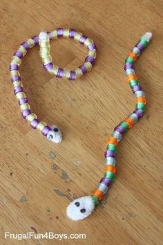 an image of a beaded halloween necklace with ghost beads on it and a white cat in the middle