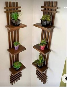 two wooden shelves with plants on them in the corner, one is made out of wood and the other has succulents