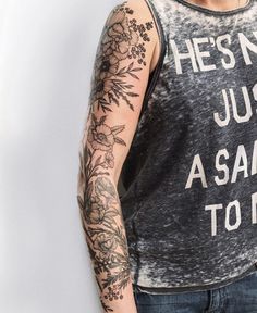 a man with tattoos on his arm wearing a tank top that says he isn't just a sam to me