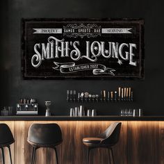 a bar with two stools next to it and a sign that says smith's lounge