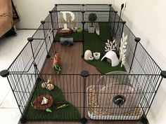 a caged in area with toys and other items on the floor, including an animal bed