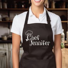 a woman wearing an apron with the word chef jennyfer on it in front of a kitchen counter