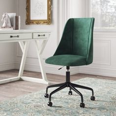 a green office chair sitting on top of a rug next to a white desk with a gold framed mirror