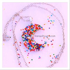 Welcome I have for you an awesome candy sprinkle moon resin necklace with real sprinkles which measure 1 3/8" wide and 1 5/8" tall on a silver chain, great for yourself or great as a gift. thank you for your support, many blessings, and take care. This listing is for the moon necklace Cresent Moon Necklace, Moon Resin, Sweet Surrender, Glitter Necklace, Beads Candy, Candy Sprinkles, Rainbow Candy, Candy Jewelry, Charm Necklaces