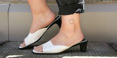 a woman's foot with a small heart tattoo on her left ankle and heel