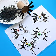 a paper plate with eyes and spider on it next to a crafting activity for kids