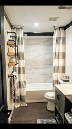 a bathroom with a toilet, sink and bathtub