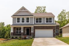 a two story brick house with white trim