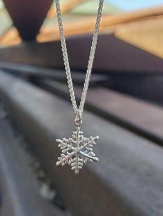 ❄️In stock and can ship immediately!❄️  Be as unique as a snowflake with this wintery necklace! This sweet sterling silver snowflake pendant is absolutely lovely.  Available with and without a sterling silver 18-inch 1.2 mm French rope chain. This is a part of our snowflake collection- check out our coordinating stud and dangle earrings too! Silver Snowflake Jewelry For Christmas, Silver Snowflake Jewelry For Holidays, Sterling Silver Snowflake Jewelry For Winter, Sterling Silver Snowflake Jewelry, Holiday Sterling Silver Necklaces, Holiday Sterling Silver Necklaces In Silver, Silver Jewelry As Winter Gift, Sterling Silver Snowflake Necklace In White Gold, Silver Jewelry For Winter Gift