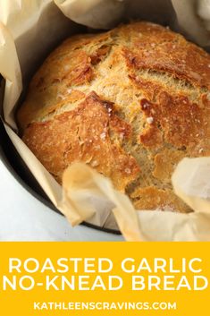 a loaf of bread in a pot with the words roasted garlic no - knead bread