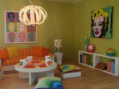 a living room filled with furniture and paintings on the wall